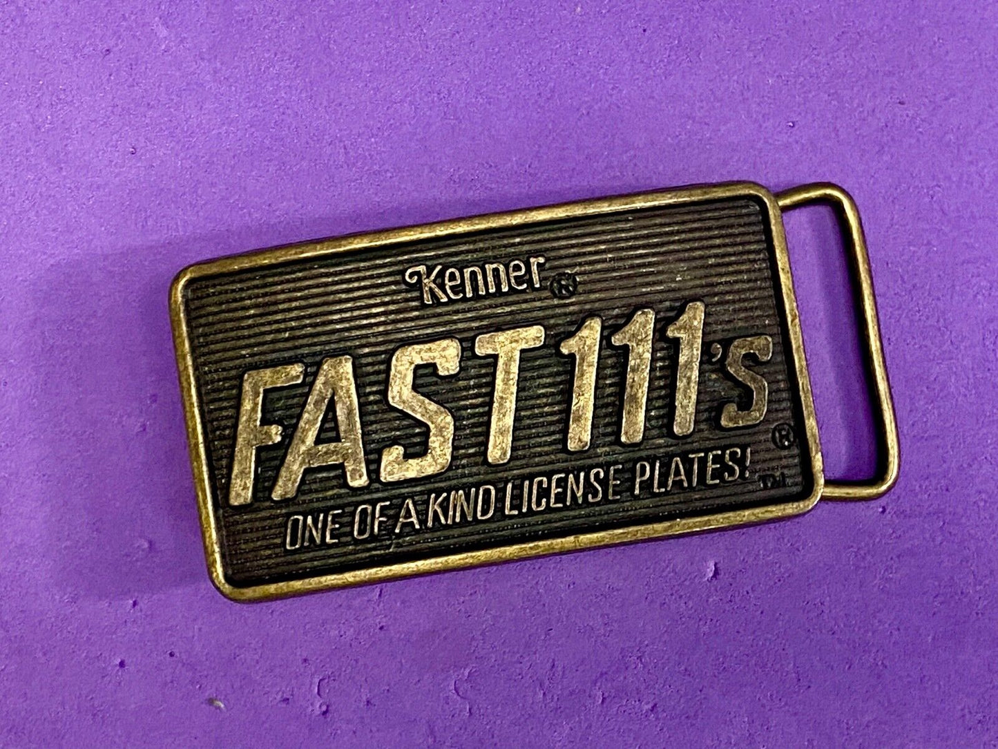 1982 Kenner Fast 111'S Company Advertisement Belt Buckle License Plates