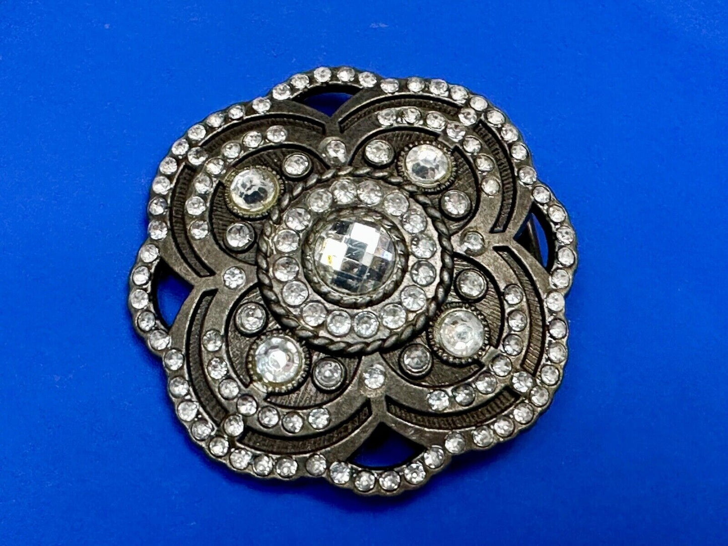 Beautiful Rhinestone accented see through flower shaped cutout belt buckle