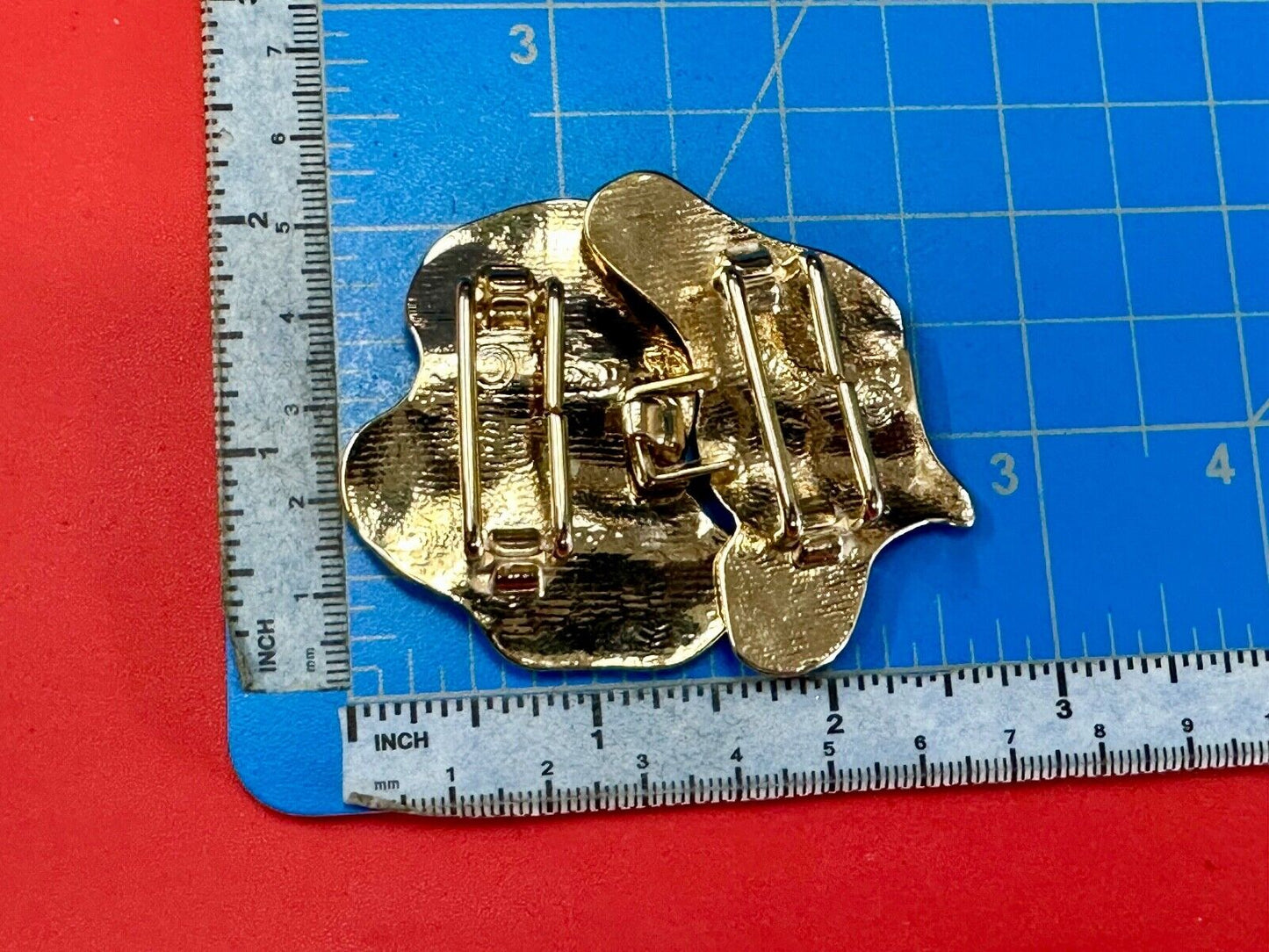 Two-piece interlocking gold tone leaf swirl theme belt slide buckle signed _____
