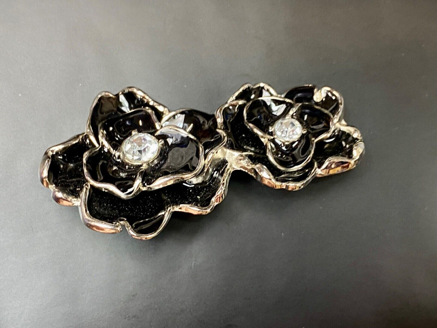 Beautiful two figural flowers with jewels as black & silver colored belt buckle