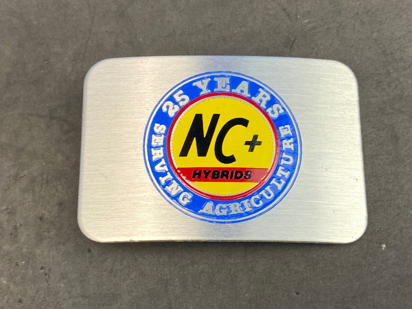 25 years serving agriculture - NC+ Hybrids belt buckle
