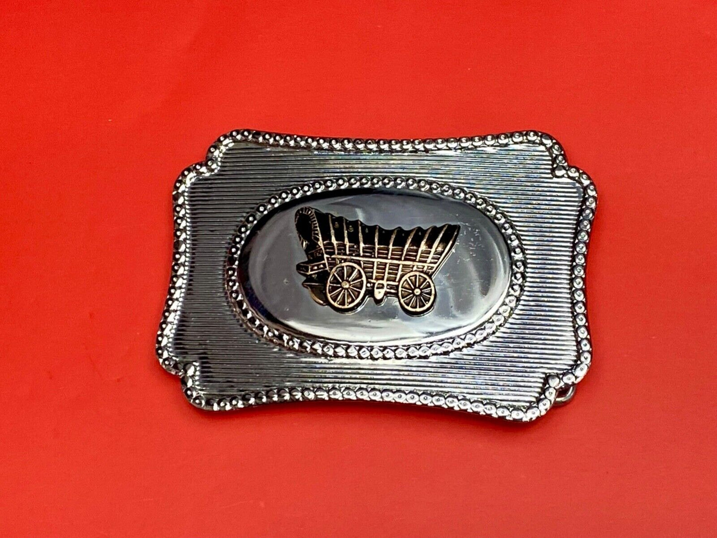 Vintage Covered wagon two tone reflective pre loved, western framed belt buckle