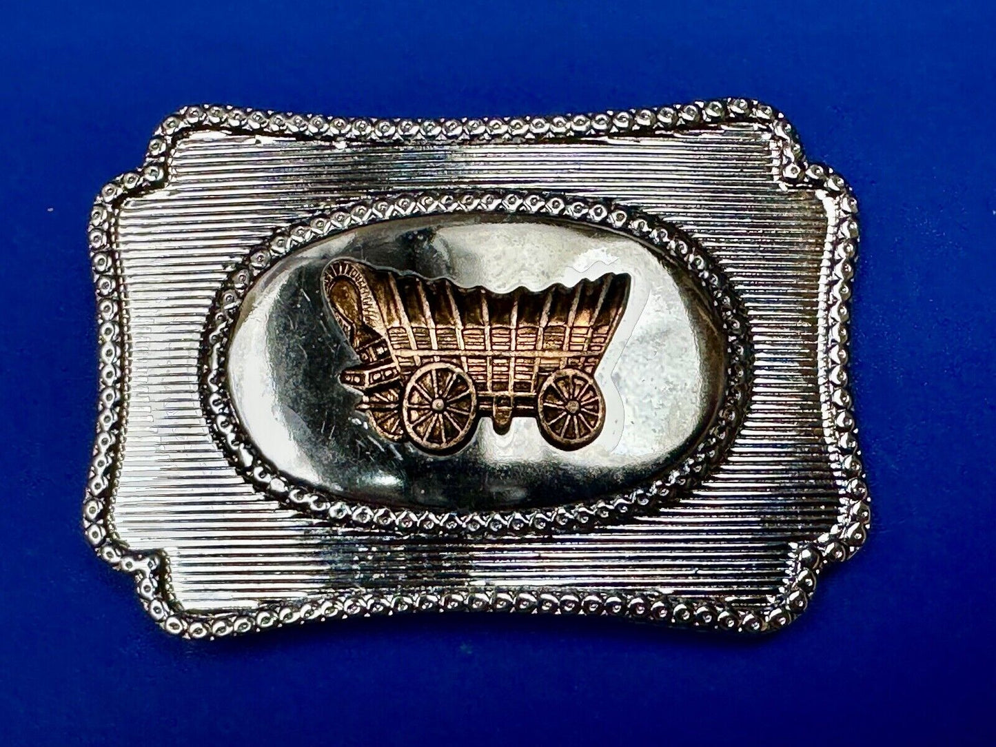 Vintage covered wagon western horse drawn transportation belt buckle