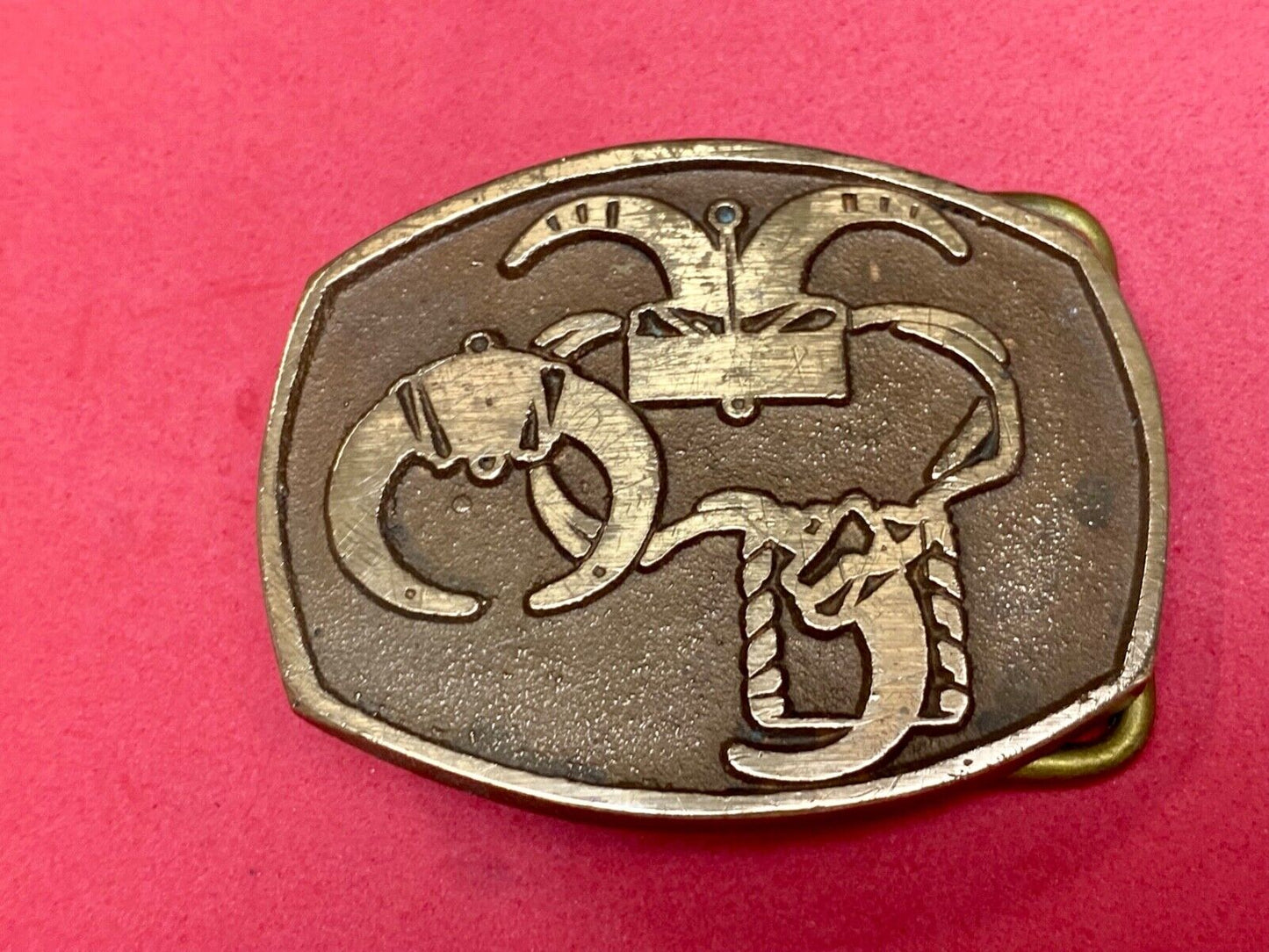unknown to me - cattle branding symbols? longhorn western? belt buckle