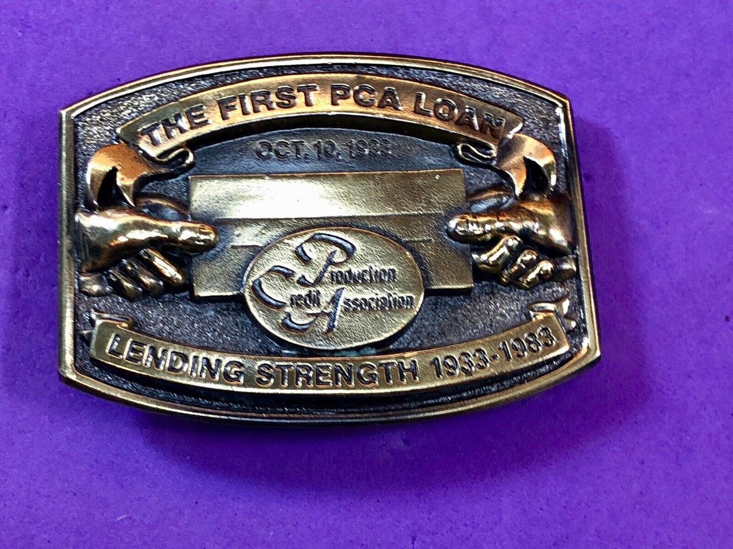 The first PCA loan belt buckle - Lending and strength production credit assn.
