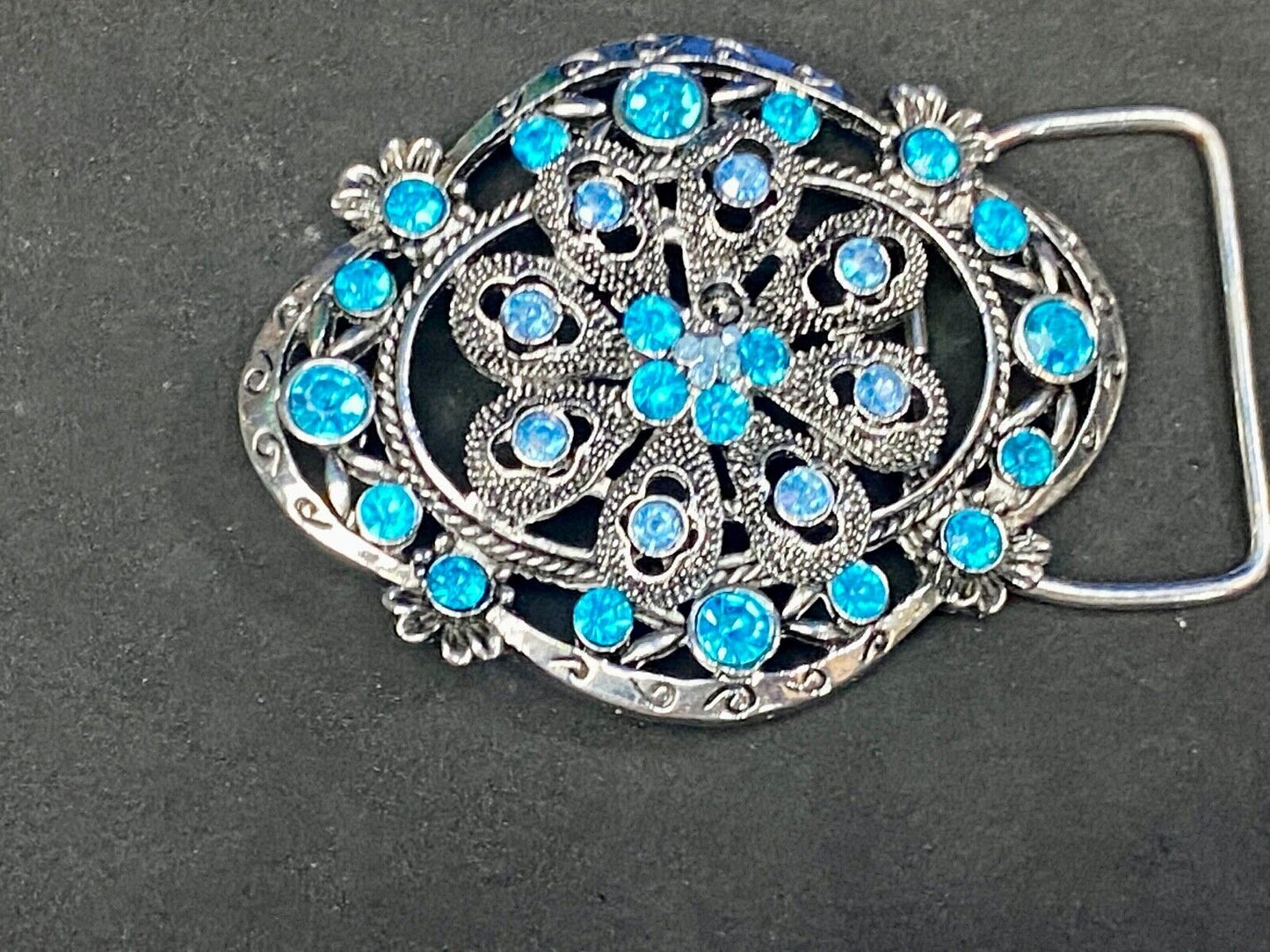BEAUTIFUL BLUE rhinestones mounted in oval shaped flower theme belt buckle