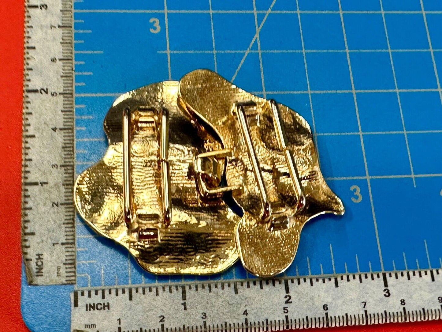 Two-piece interlocking gold tone leaf swirl theme belt slide buckle signed _____