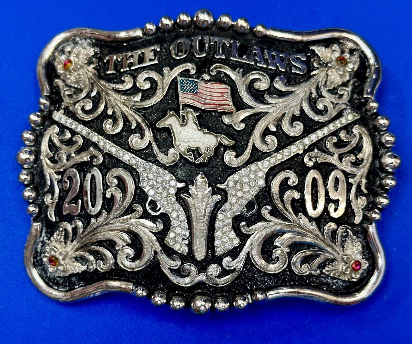 The Outlaws Rodeo Cowboy Trophy 2009 Flag Belt Buckle - Crossroads bucklesTexas