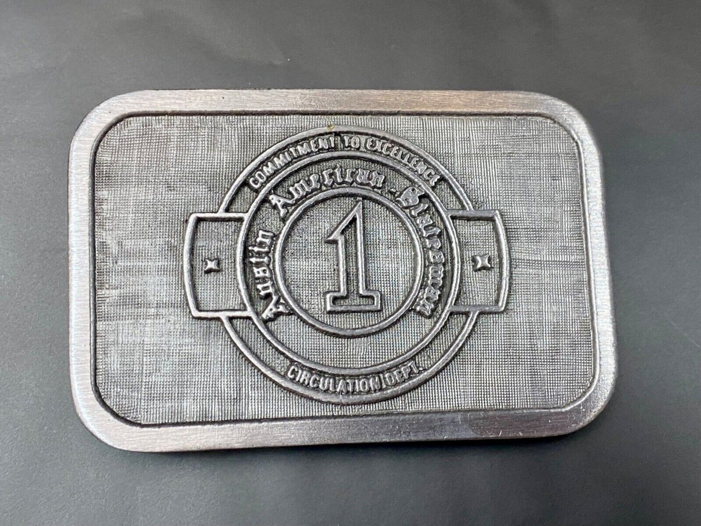 Asian American Circulation Dept Commitment to excellence belt buckle hit-line