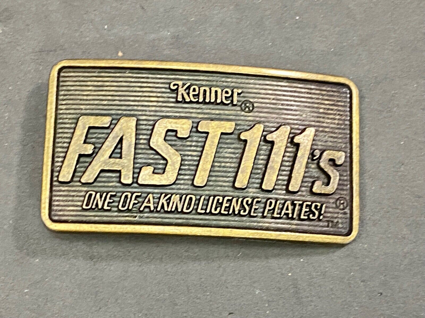 1982 Kenner Fast 111'S Company Advertisement Belt Buckle License Plates