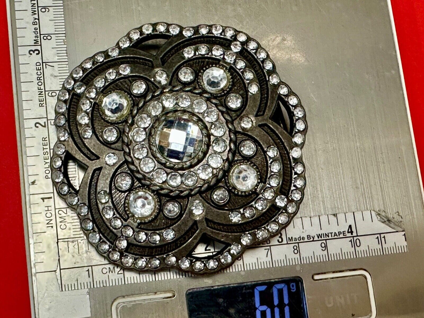 Beautiful Rhinestone accented see through flower shaped cutout belt buckle