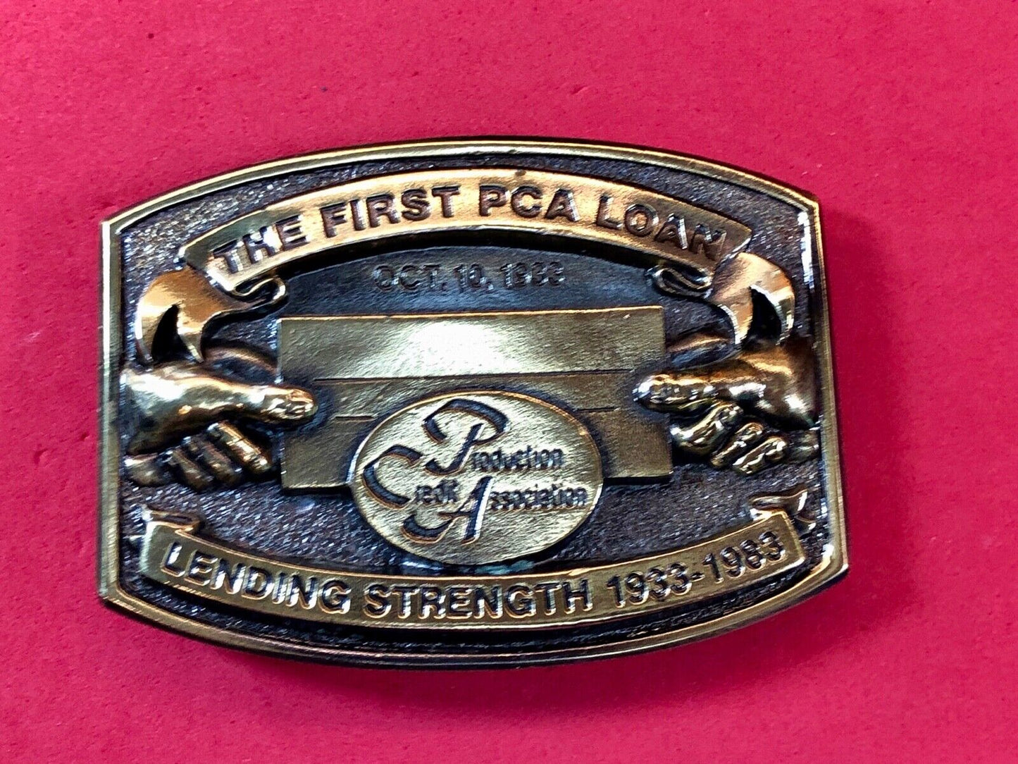 The first PCA loan belt buckle - Lending and strength production credit assn.