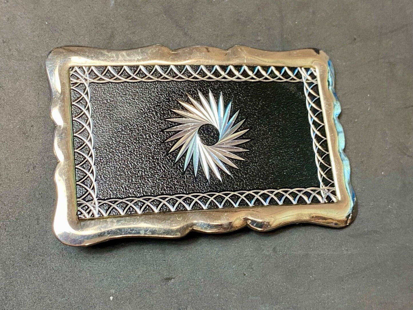 Black and silver color etched starburst pattern rectangular belt buckle