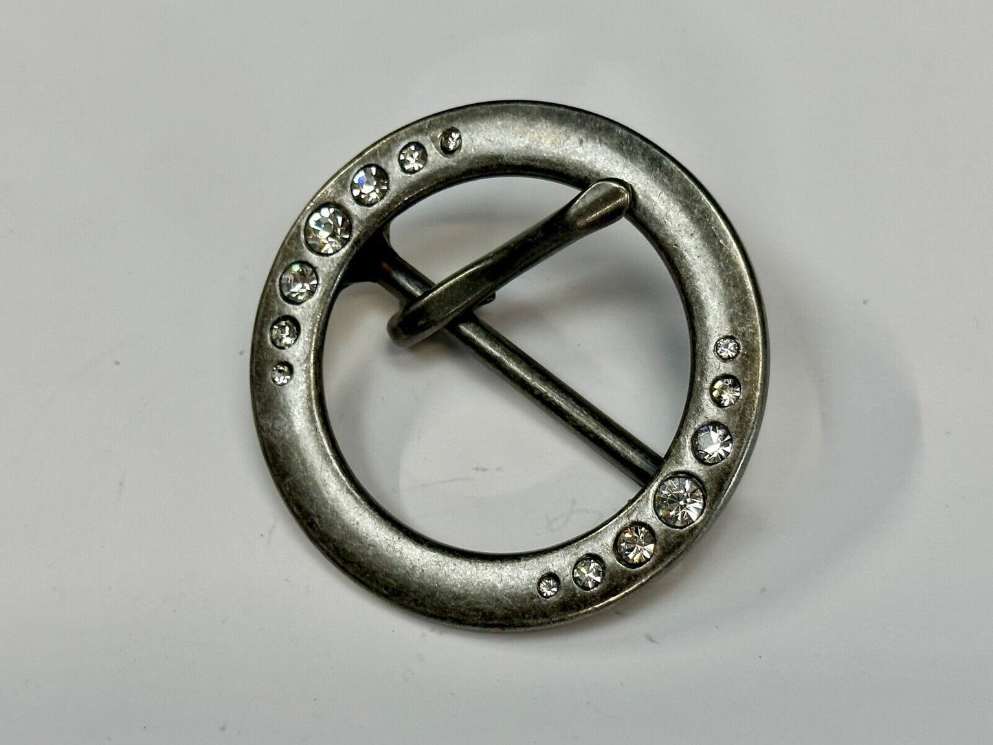 2" Round silver tone belt buckle with graduated rhinestone sized