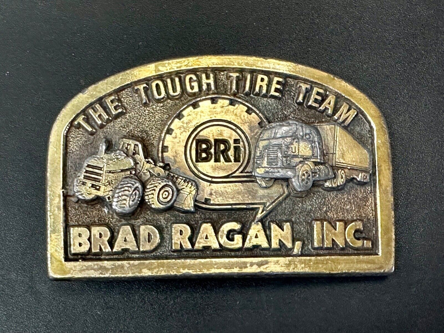 The Tough Tire Team BRi Brad Ragan, Inc. vintage belt buckle by Spec-Cast