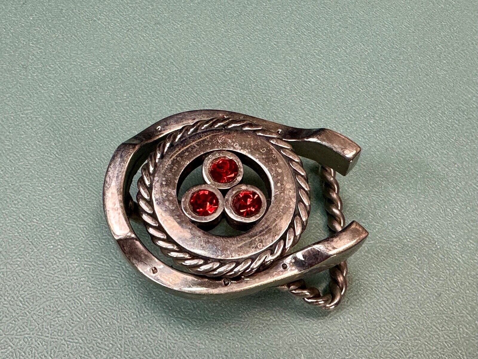 artisan circle pattern rope centerpiece red dots horseshoe shaped belt buckle