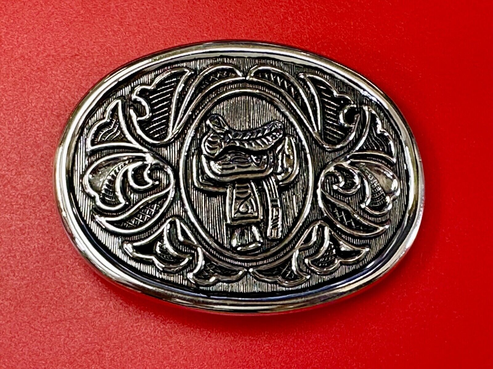 Vintage Cowboy's Horse Saddle ornate flower swirl oval belt buckle by Avon