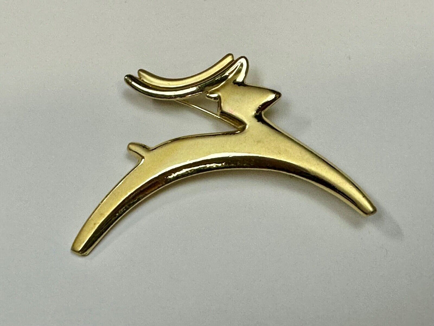 Abstract gold tone running deer - Vintage Christmas Holliday Brooch by AJC