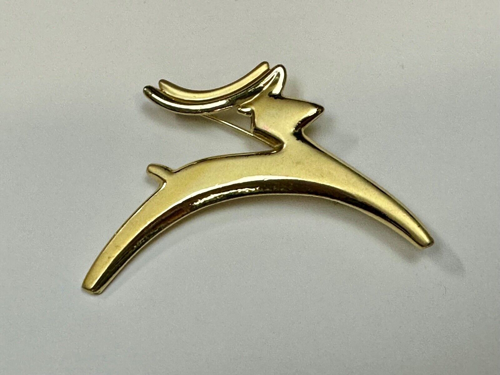 Abstract gold tone running deer - Vintage Christmas Holliday Brooch by AJC