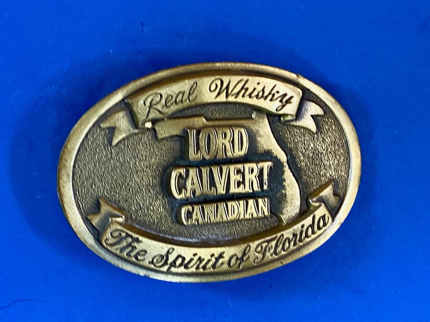 Vintage Lord Calvert Canadian Real Whisky.  Spirit Of Florida Belt Buckle 