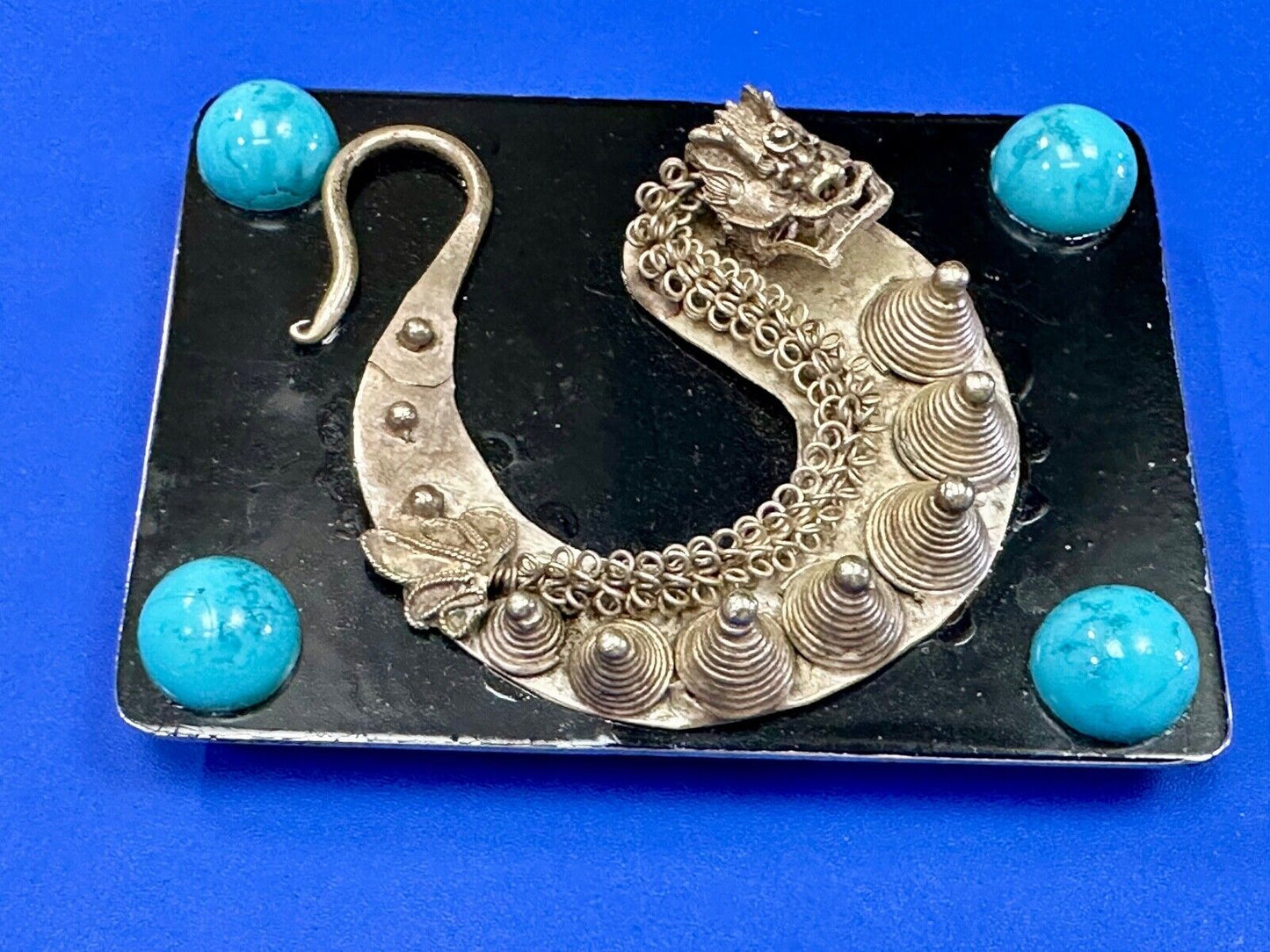 Artisan Dragon theme rectangular belt buckle with turquoise colored corner accts