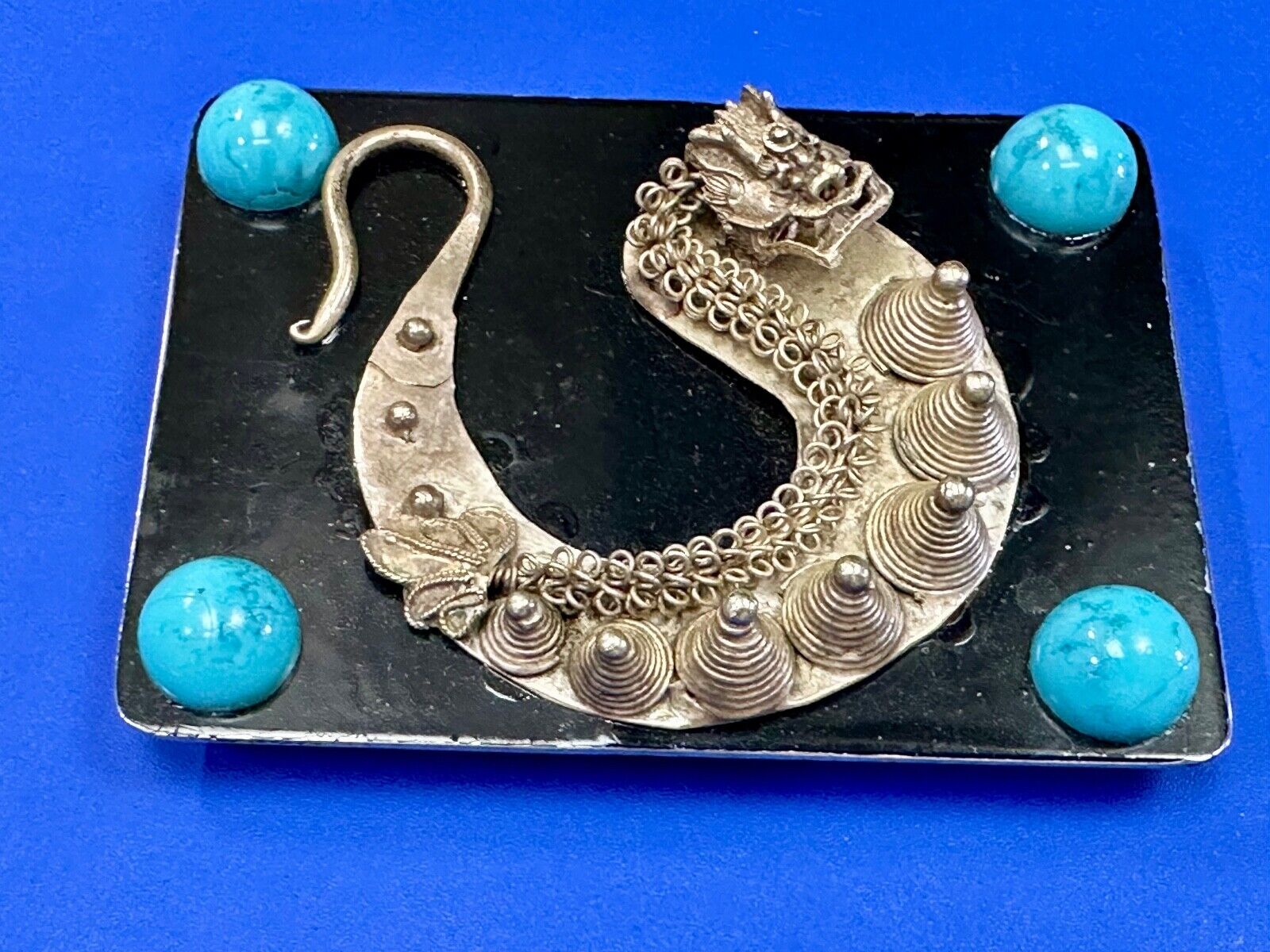 Artisan Dragon theme rectangular belt buckle with turquoise colored corner accts