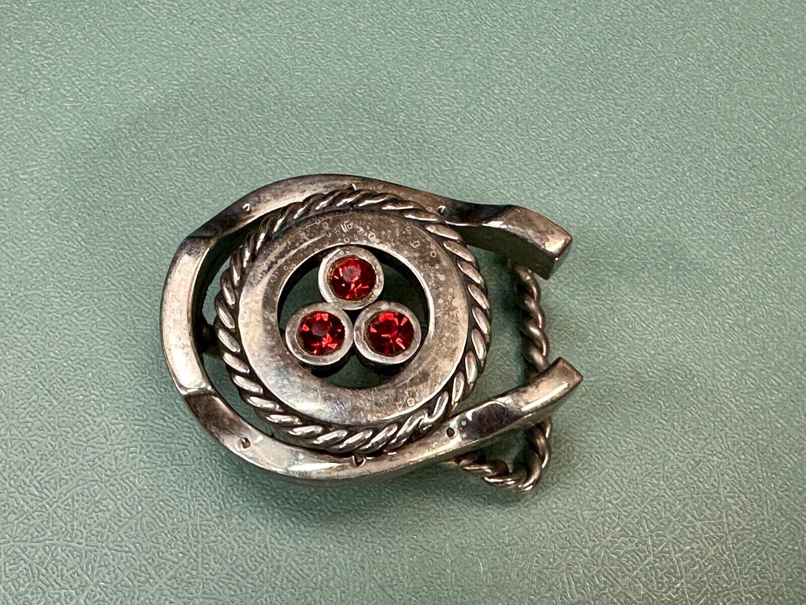 artisan circle pattern rope centerpiece red dots horseshoe shaped belt buckle