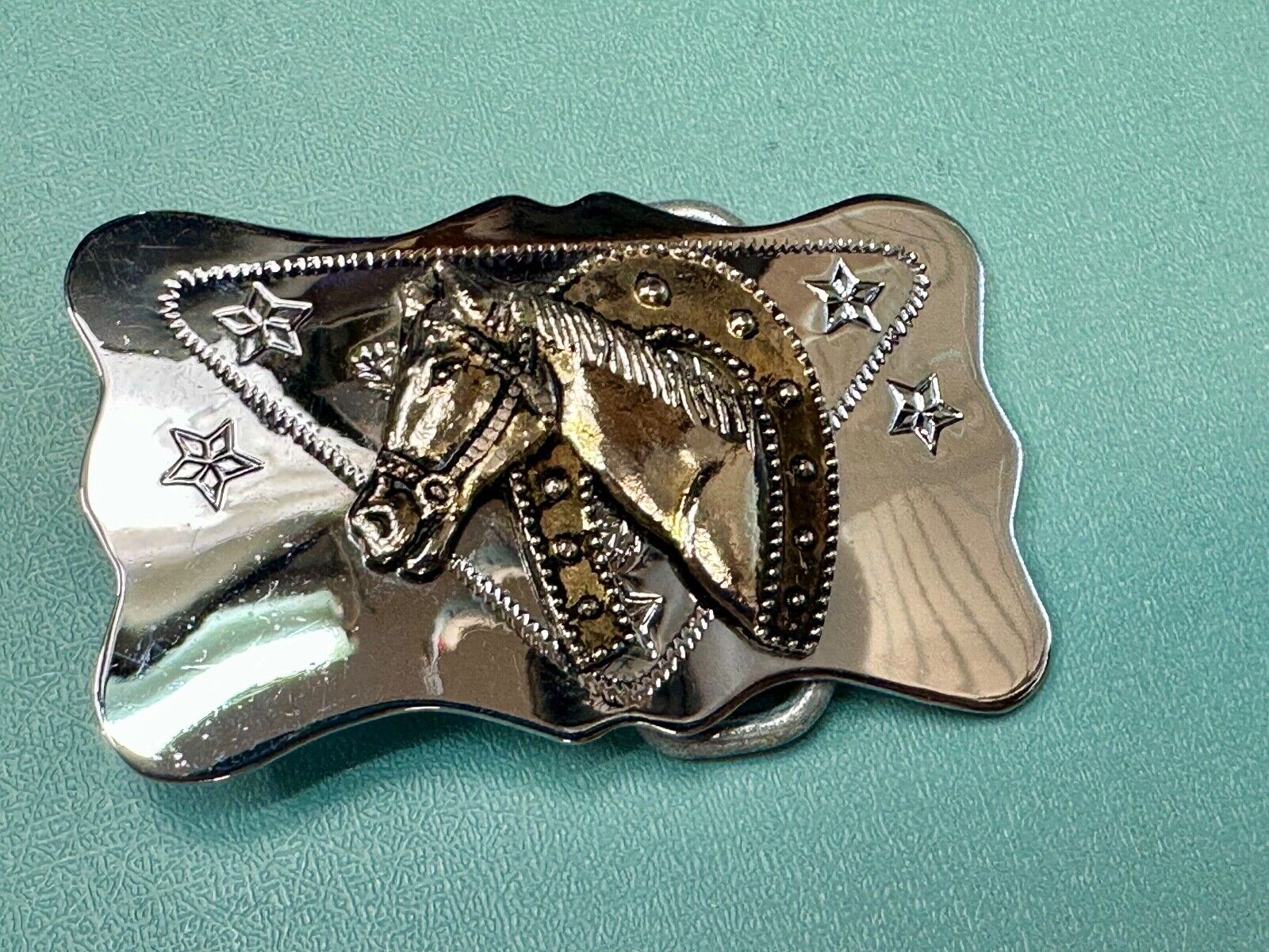 Vintage horse head through lucky horseshoe on reflective western belt buckle