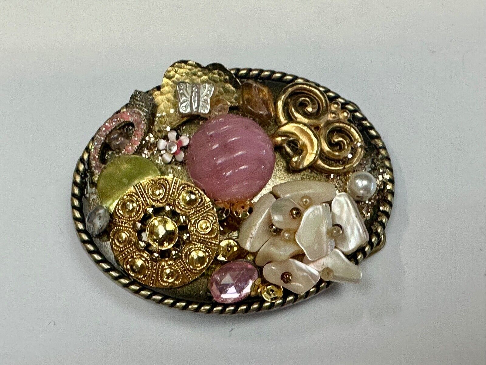 Artisan Abstract flowers made of mixed material on gold tone oval belt buckle