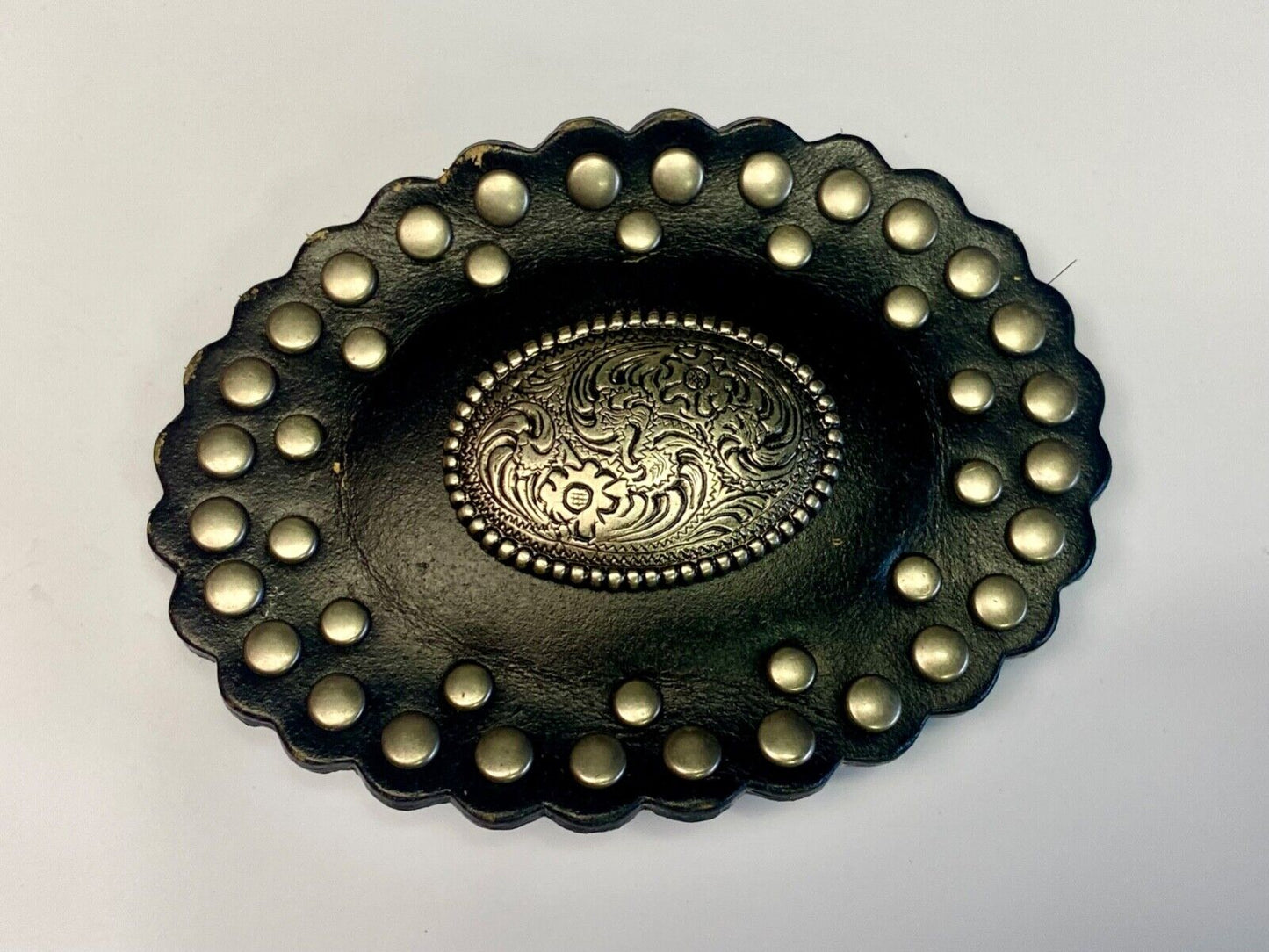 4" wide studded black leather oval belt buckle with flower swirl center