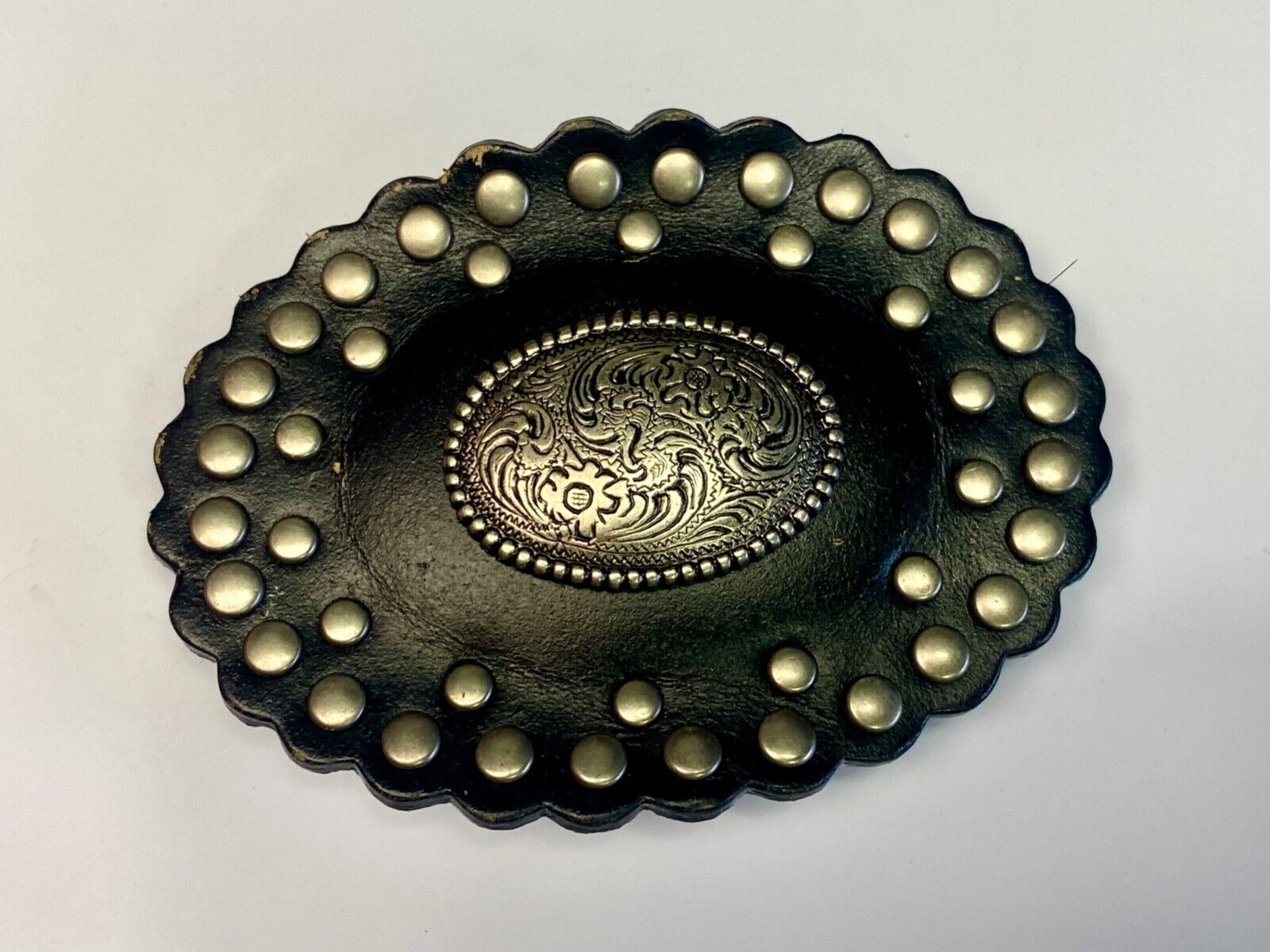 4" wide studded black leather oval belt buckle with flower swirl center