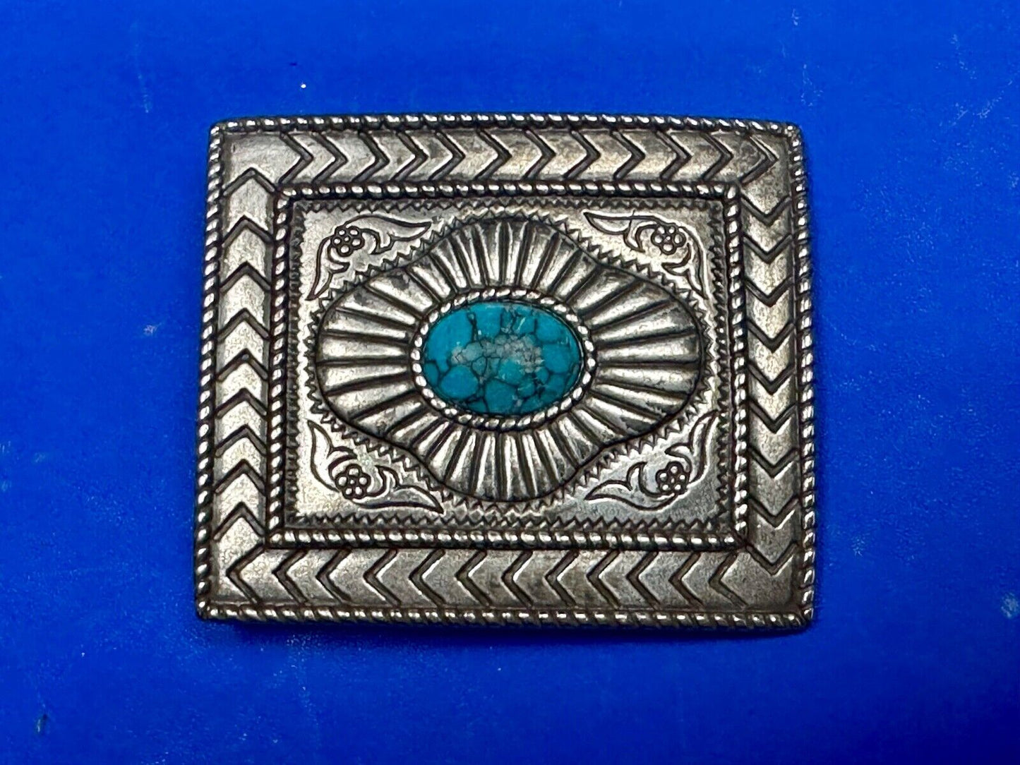 Turquoise Cab centerpiece on southwestern pattern silver tone belt buckle