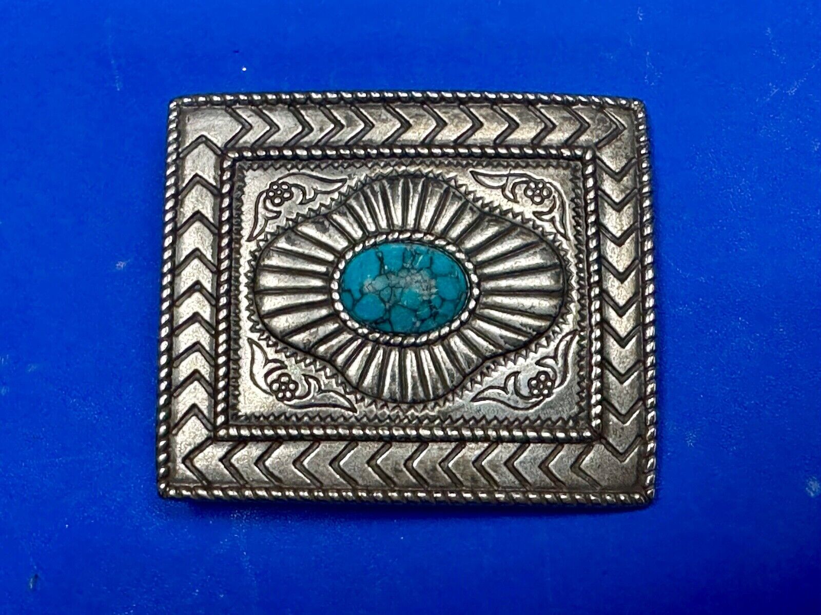 Turquoise Cab centerpiece on southwestern pattern silver tone belt buckle