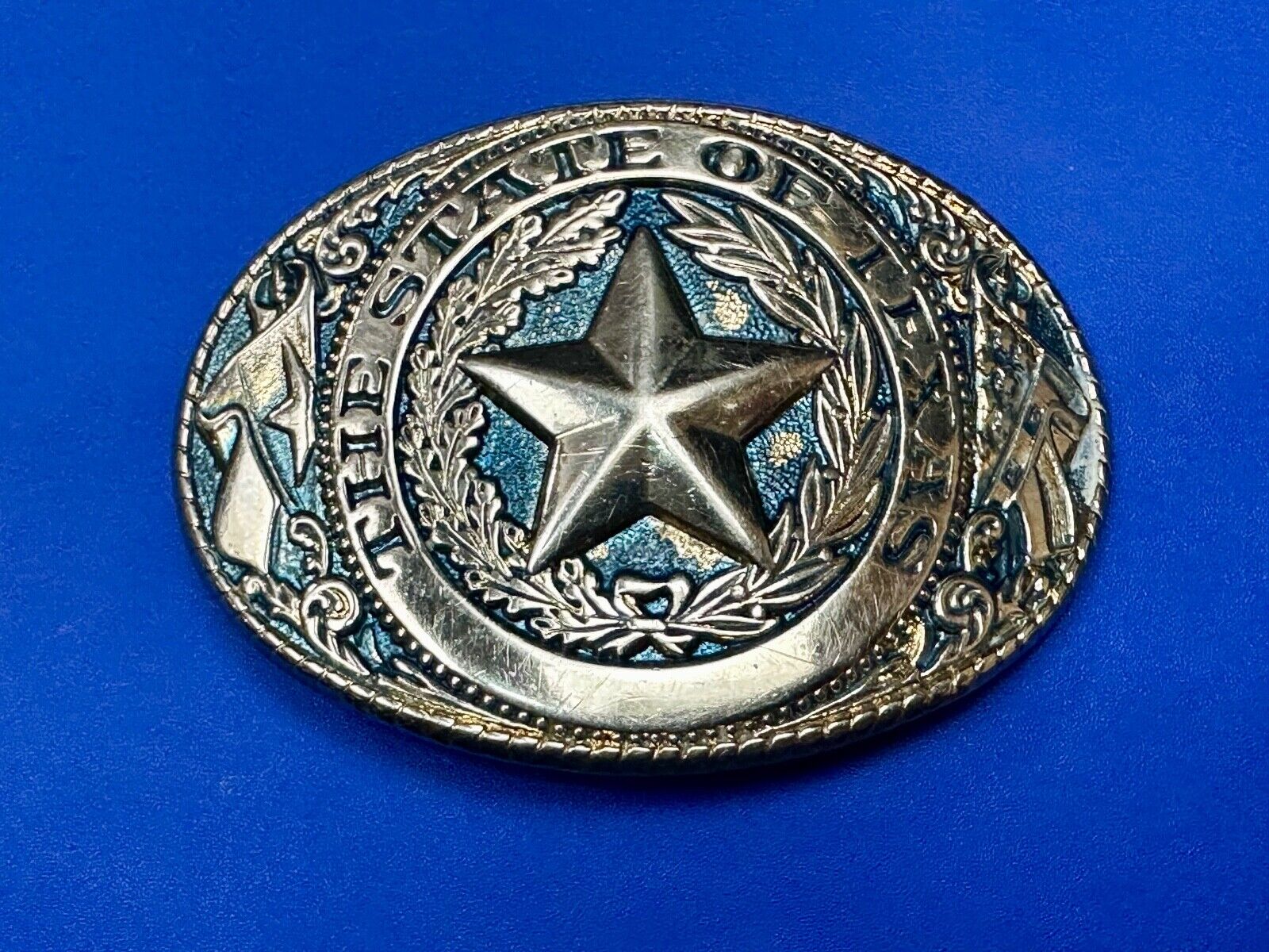 The Great State of Texas - gold color star belt buckle with blue colored accents