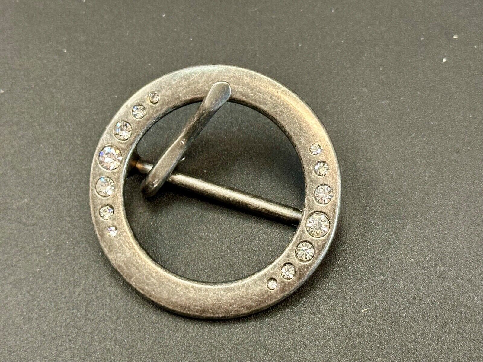 2" Round silver tone belt buckle with graduated rhinestone sized