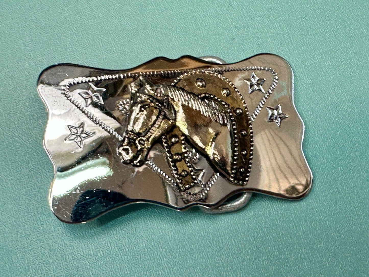 Vintage horse head through lucky horseshoe on reflective western belt buckle