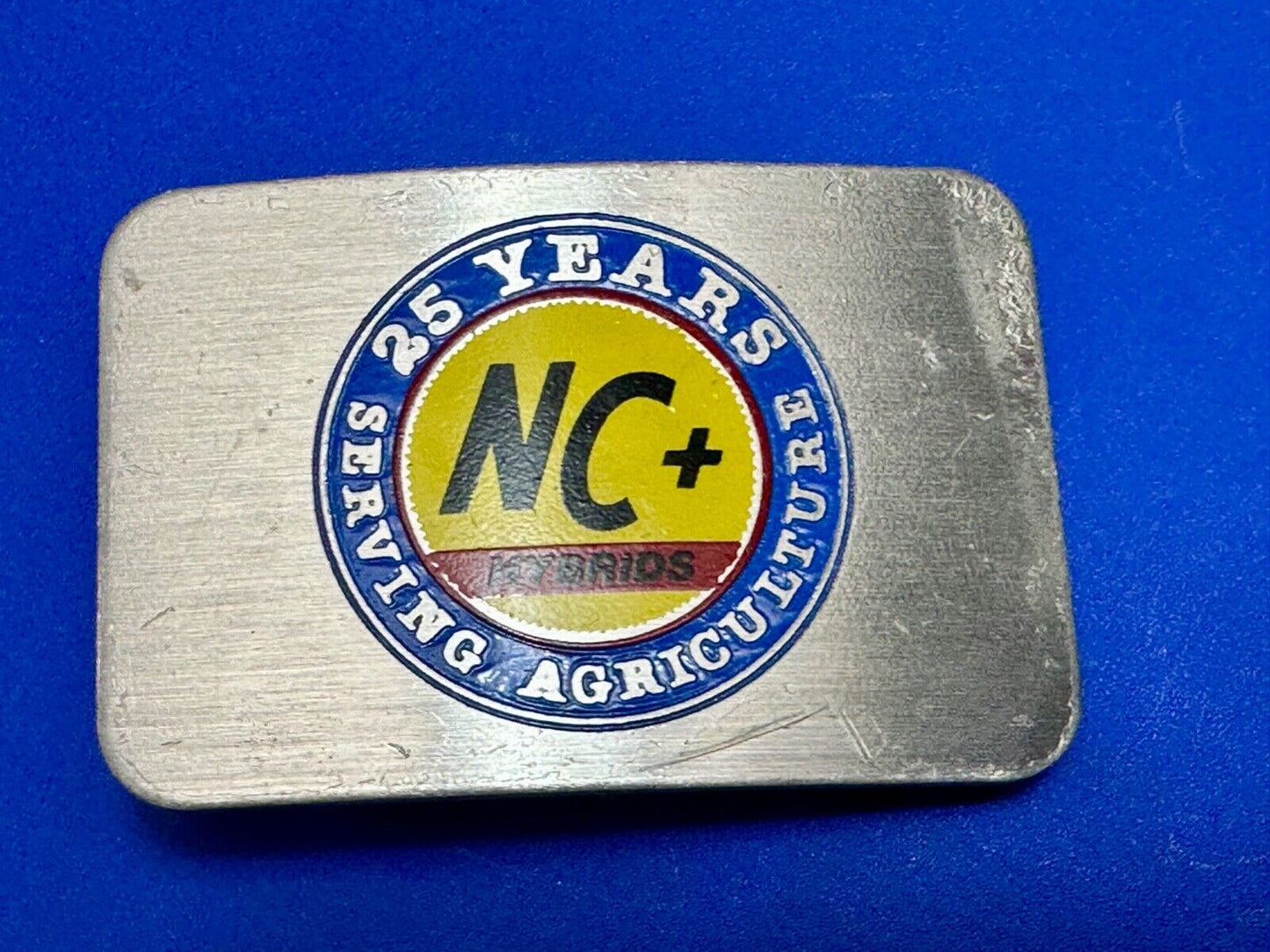 25 years serving agriculture - NC+ Hybrids Farmers Agriculture belt buckle
