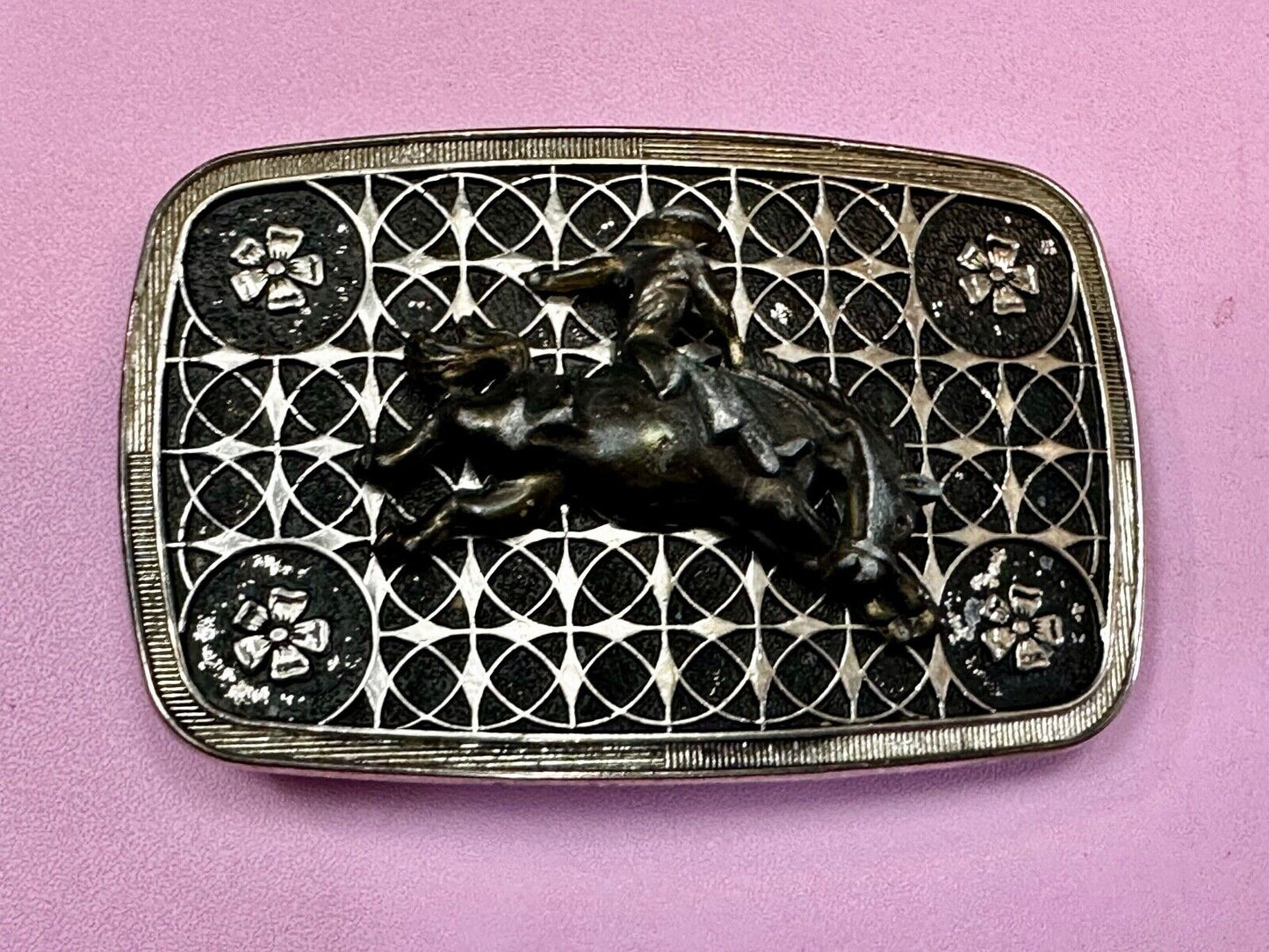 Vintage Cowboy on Saddle Bronc Western belt buckle with mesh pattern background