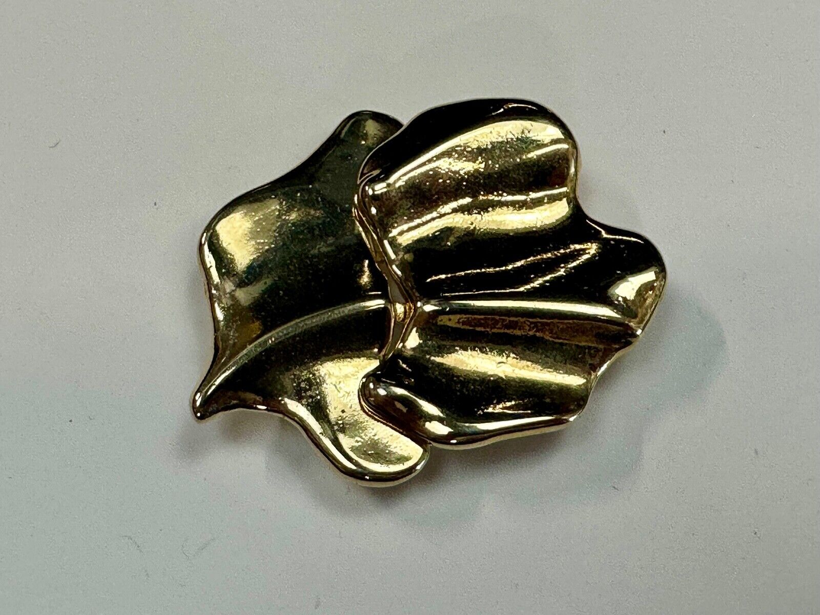 Two-piece interlocking gold tone leaf swirl theme belt slide buckle signed _____