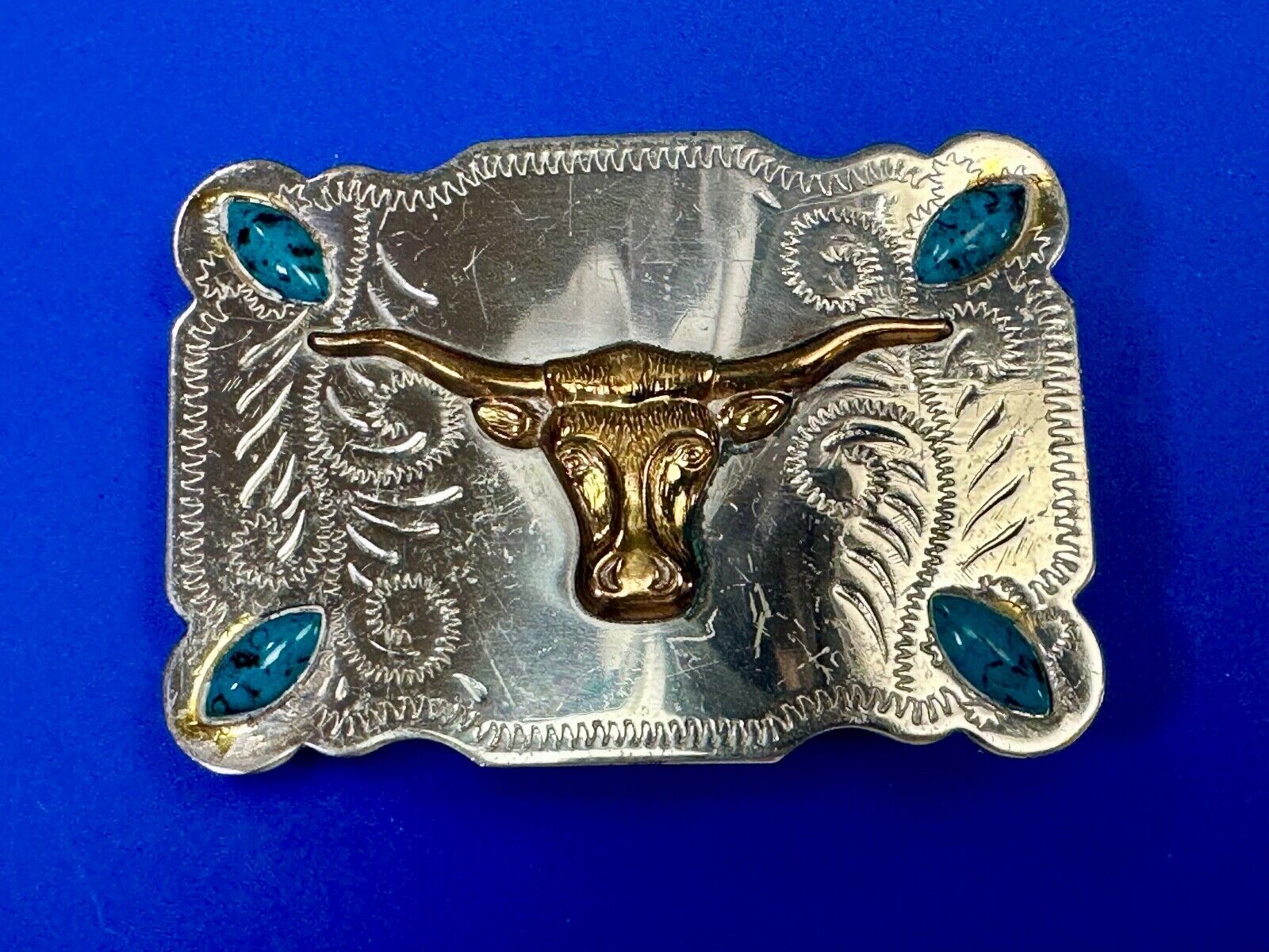 The Longhorn cow steer western nickel silver belt buckle with turquoise accents