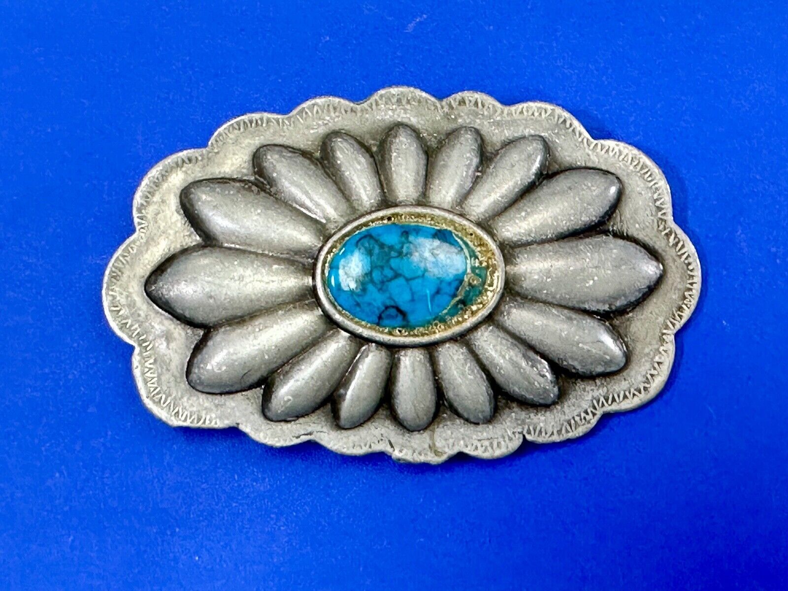 Turquoise stone centered on Vintage metal flower theme belt buckle