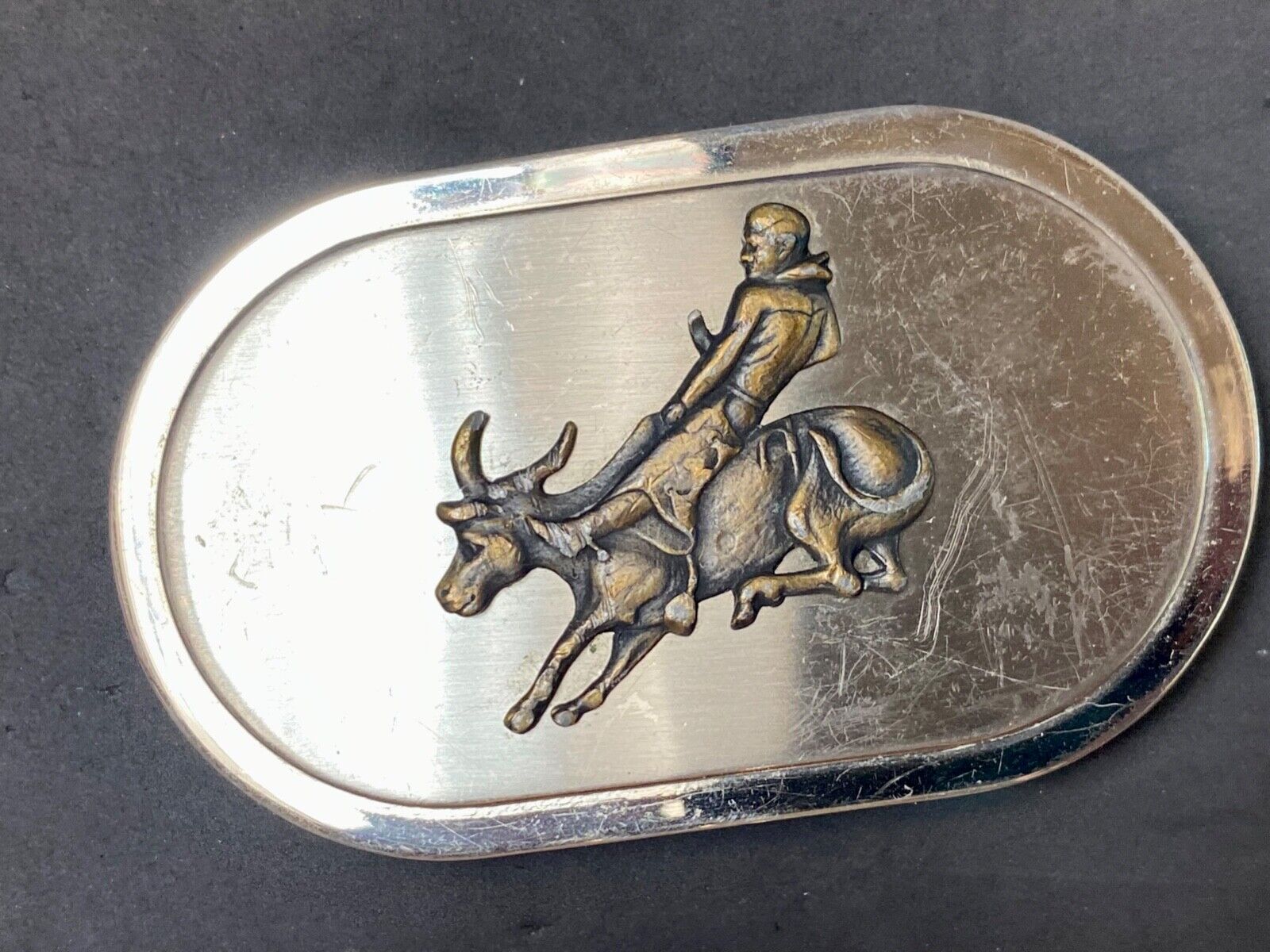 Vintage western oval Rodeo Cowboy on bucking bronc? bull numbered belt buckle