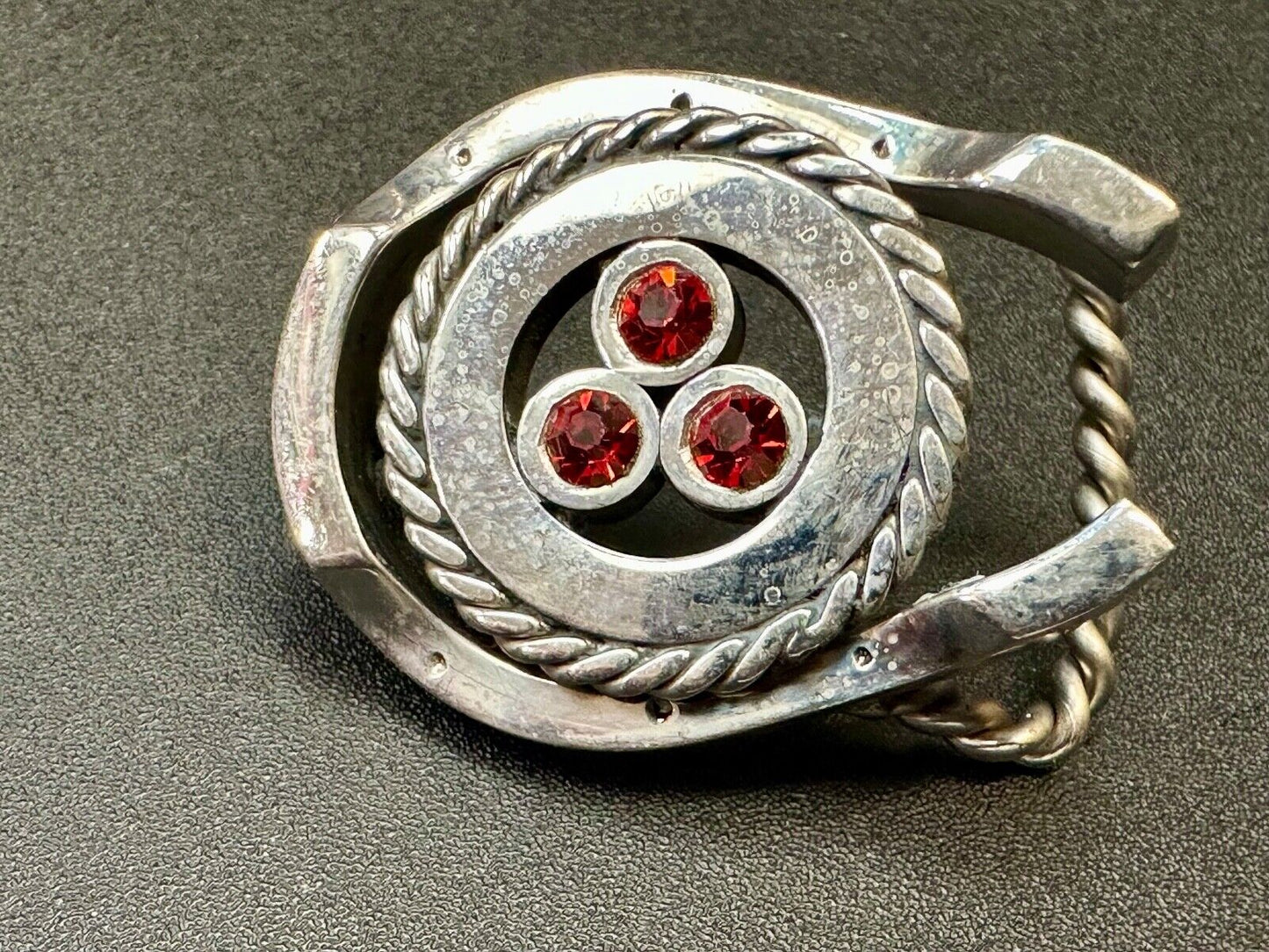 artisan circle pattern rope centerpiece red dots horseshoe shaped belt buckle