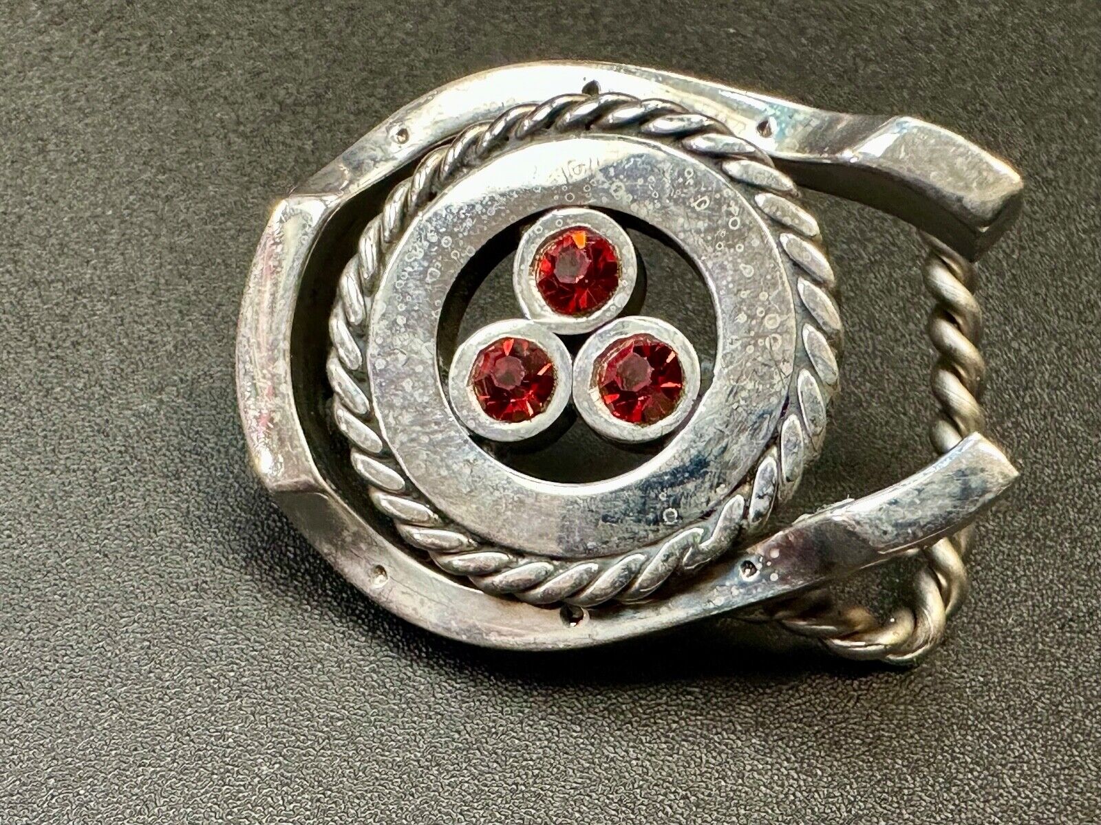 artisan circle pattern rope centerpiece red dots horseshoe shaped belt buckle