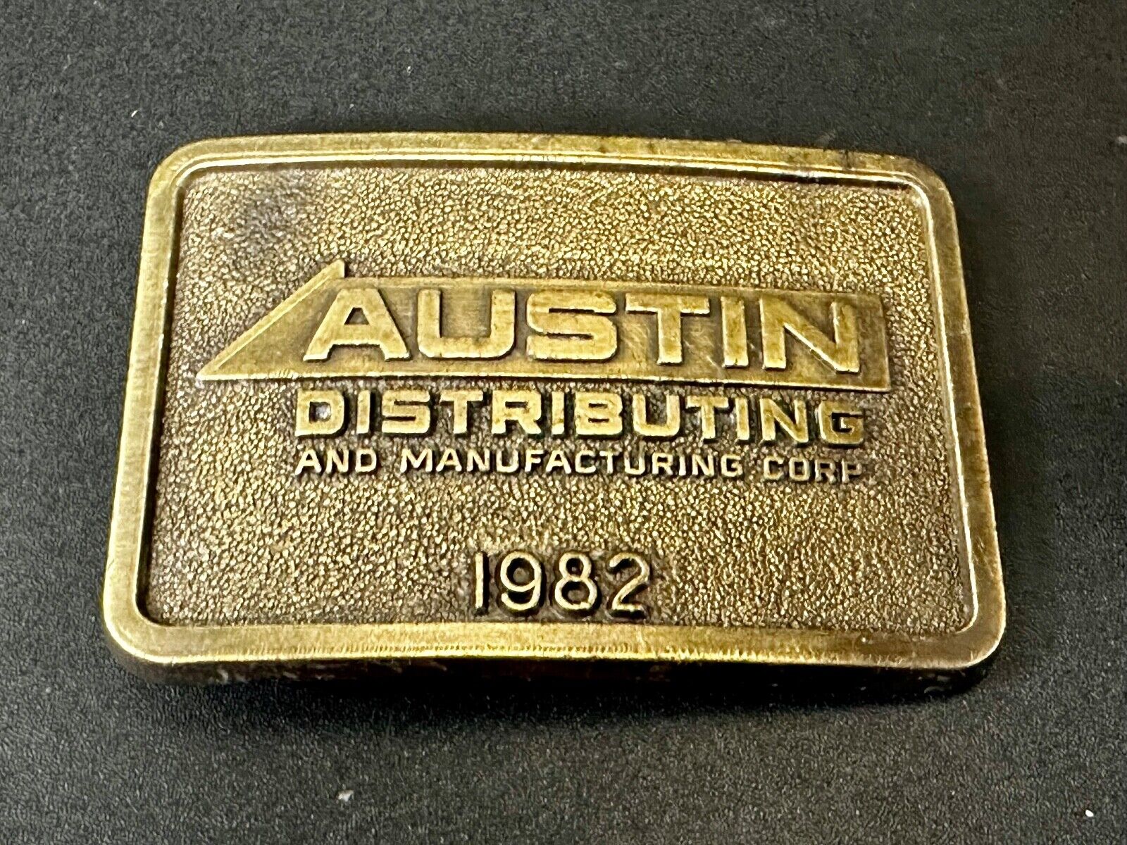 Austin Texas Distributing and Manufacturing 1982 Advertisement Promo Belt Buckle