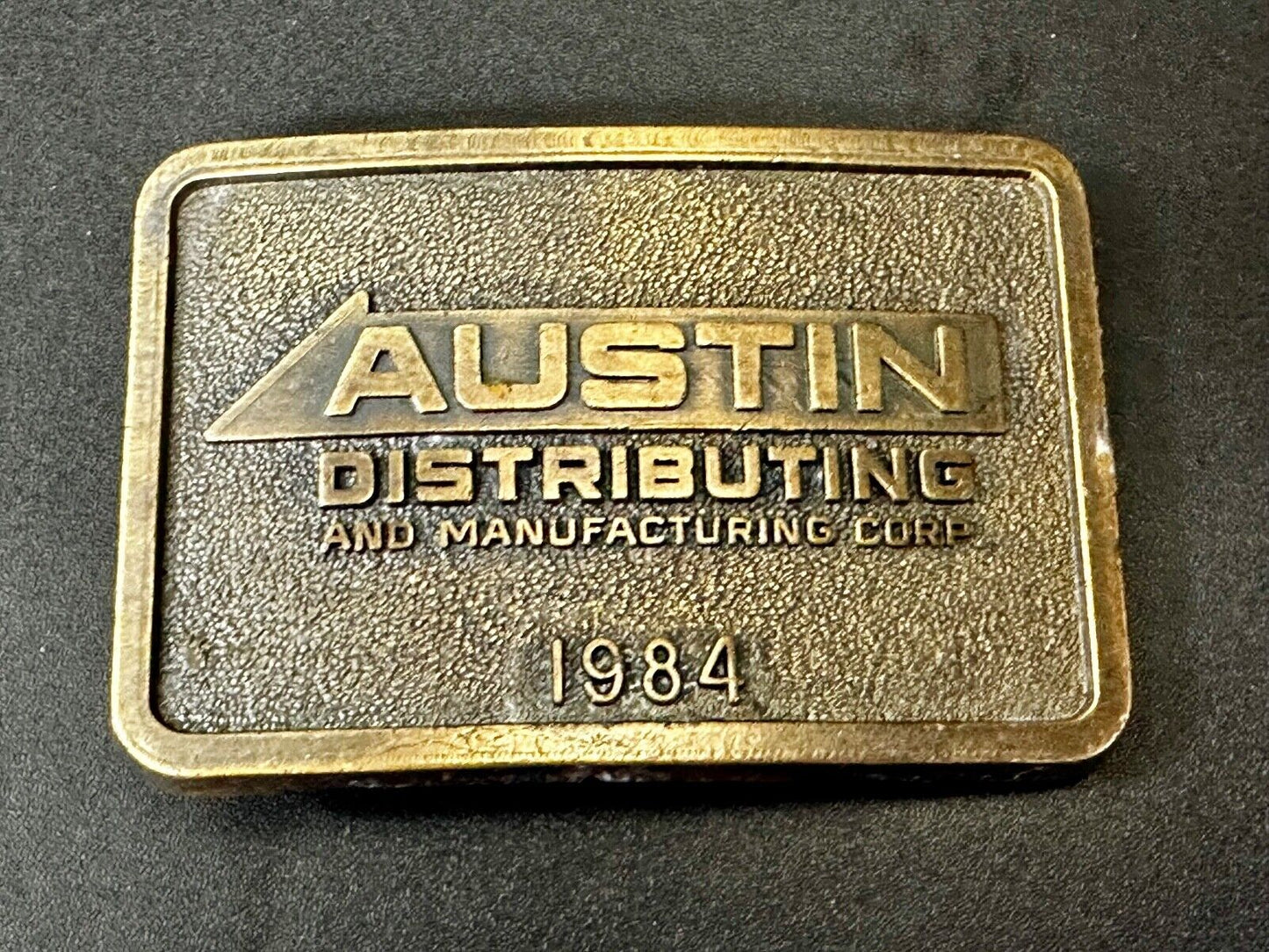Austin Texas Distributing and Manufacturing 1984 Advertisement Promo Belt Buckle