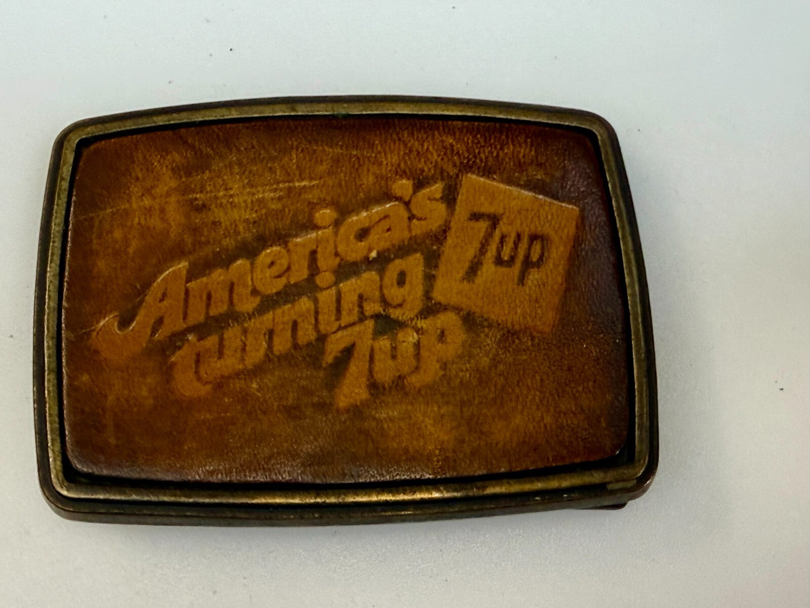 America's Turning 7up Embossed Leather on Metal Advertising Promo Belt Buckle