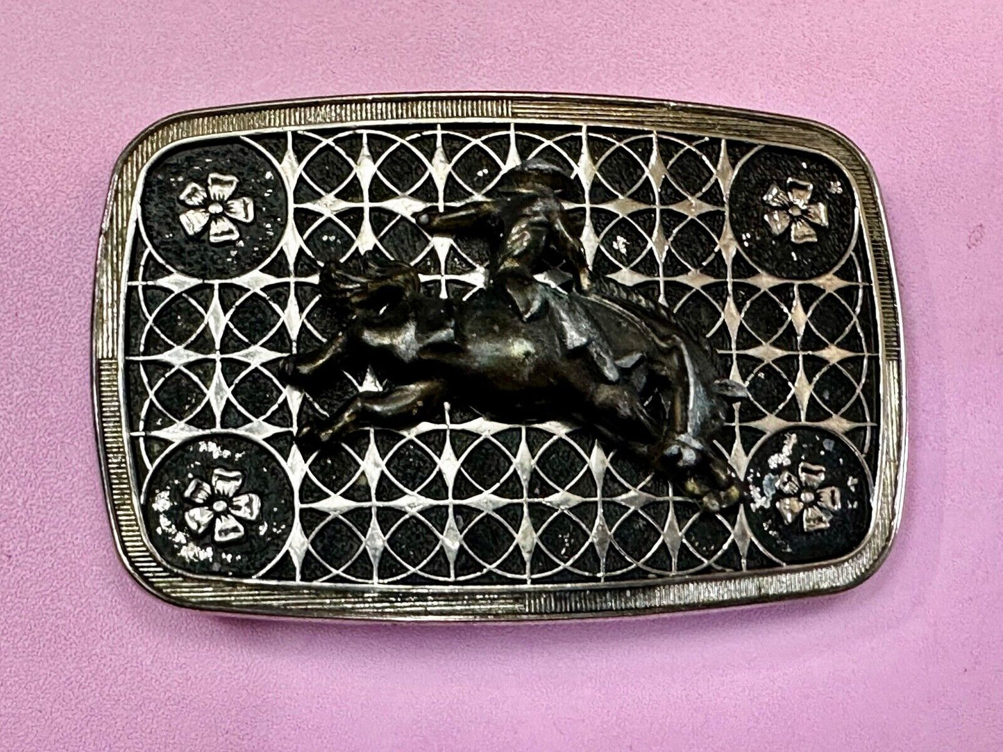 Vintage Cowboy on Saddle Bronc Western belt buckle with mesh pattern background
