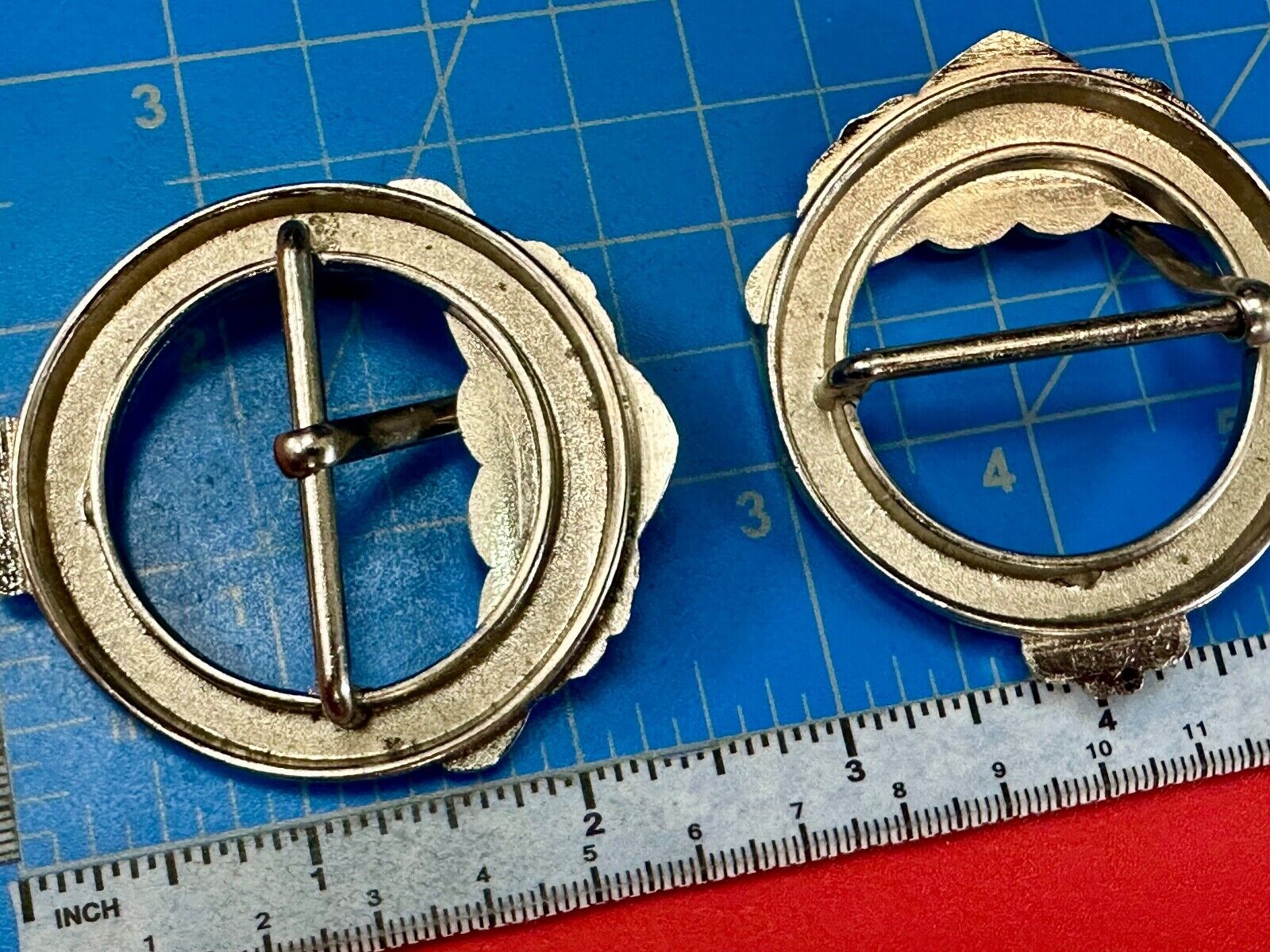 Two Kathy Van Zeeland signed silver tone round heart accented belt buckles