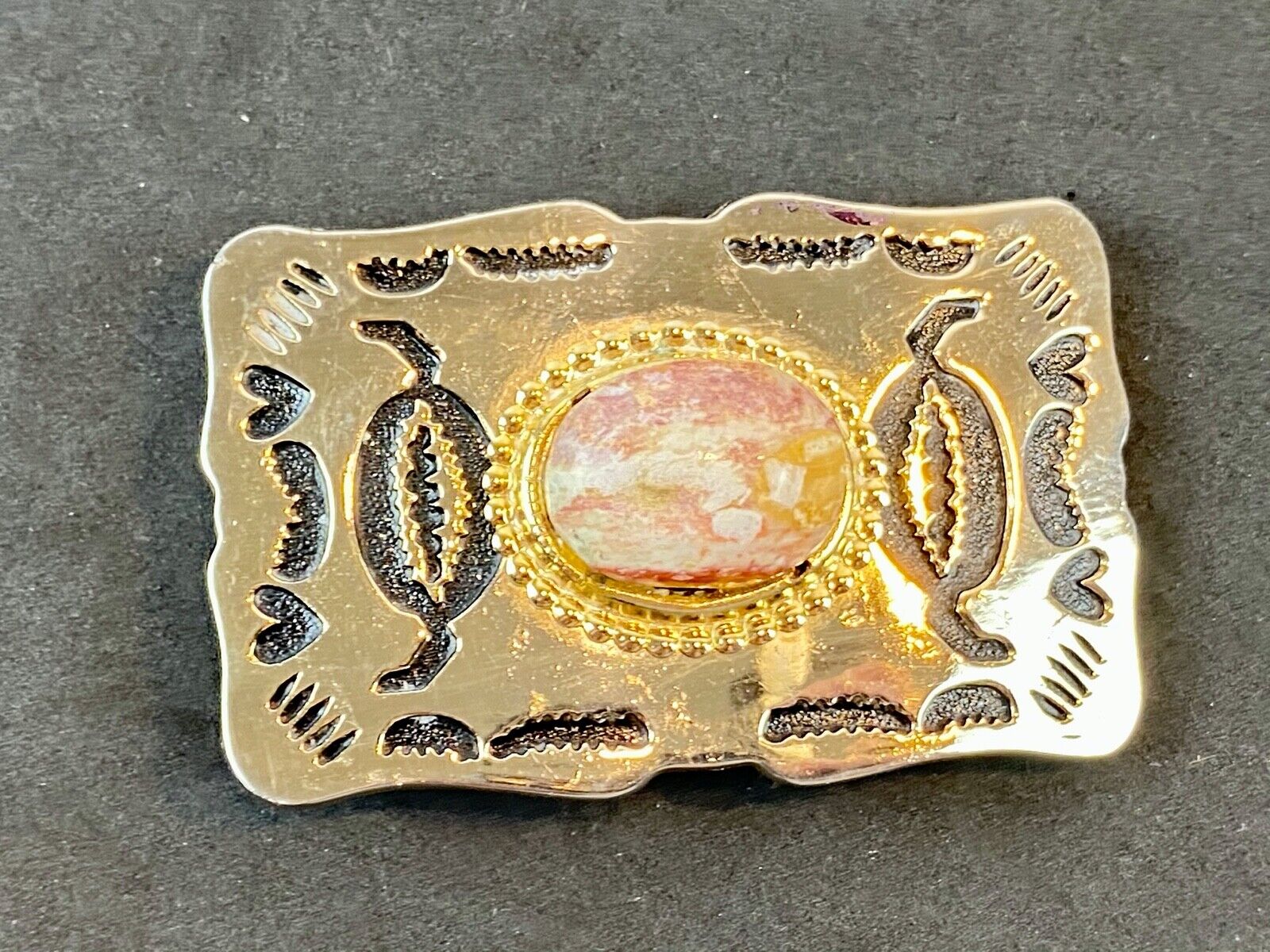 unknown multi layered colored stone as centerpiece in western belt buckle